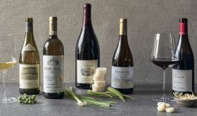 Still life of wine bottles and Asian greens