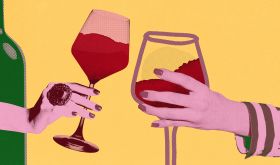 female urban hands each holding a glass of wine - Shutterstock