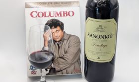 Caption: A Columbo DVD box set with a bottle and glass of Kanonkop Pinotage