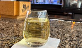 A glass of Sauvignon Blanc at an airport bar