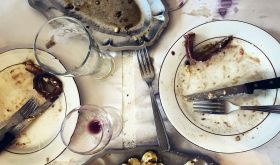 Emptied plates and glasses after a meal by Jason Lowe