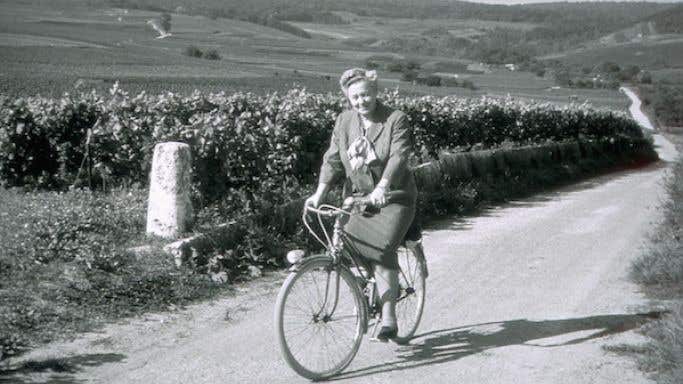Madame Lily Bollinger on a bike in the vineyards