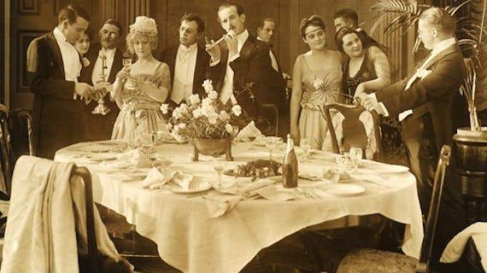 old sepia photograph of dinner party