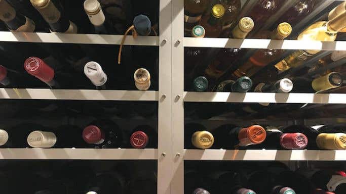 Bottles of wine on racks in a cellar