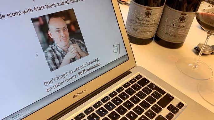 Laptop and wine bottles ready for an online wine tasting