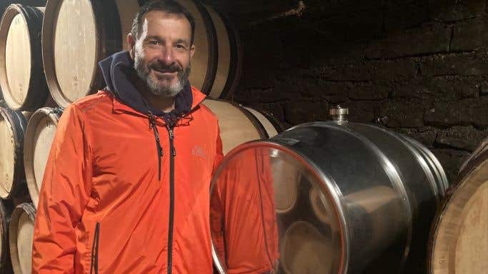 Jean-Marc Roulot in his Meursault cellar with a stainless steel barrel
