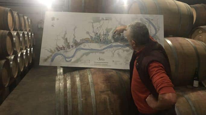 Jean-Luc Jamet in his cellar with a map of Côte Rôtie