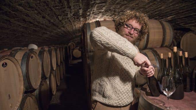 Sylvain Pataille opens bottles in his cellar
