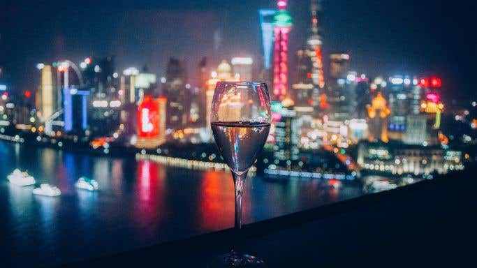 Glass of wine against Shanghai skyline