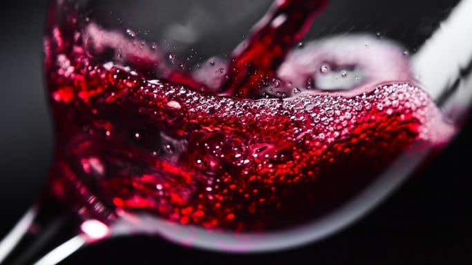 Generic red wine splashing into a glass