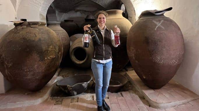Teresa Caeiro holds a bottles of her NaTalha and a Ferrapo and a palhete or petroleiro wine (a blend of red and white grapes) she makes with her grandfather at the Gerações de Talha (Generations of Talha) winery in Vila de Frades, Alentejo, Portugal