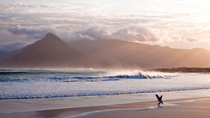 A surfer on the beach in South Africa