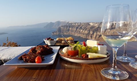 Wine and food on Santorini with Fira in the distance