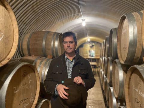 Jim Prosser stands among the barrels at JK Carriere, his winery in Oregon's Chehalem Mountains AVA.