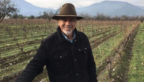 Alvaro Espinoza in a hat and jacket in his vineyards in Chile in winter.