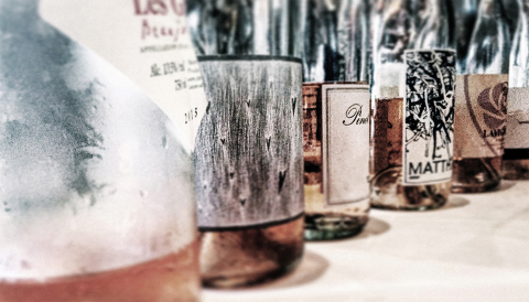 A stylized photo of rosé wine bottles