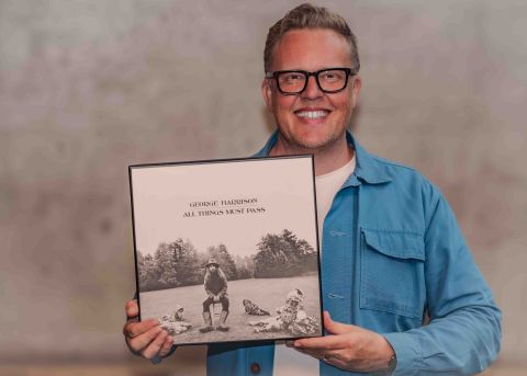 Olly Smith holding a George Harrison LP cover