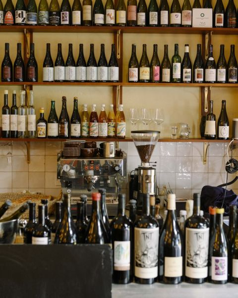 Camille restaurant interior with wine bottles and coffee ginder