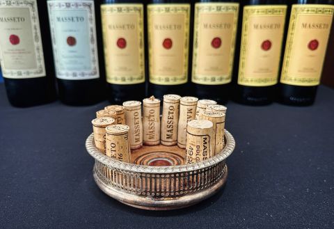 Corks from Masseto in the foreground; bottles of Masseto in the background