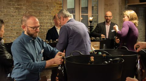 Six members of JancisRobinson.com opening champagne bottles