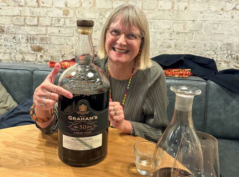 Jancis Robinson pointing at a big bottle of Grahams 50-year-old tawny port