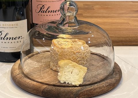 Langres under a cloche with champagne bottles in background
