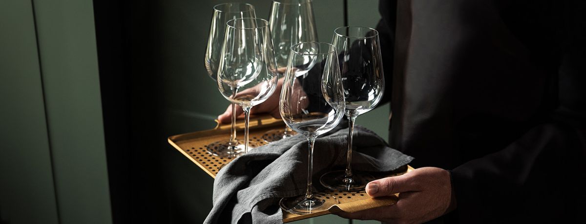 Wine glasses being carried on a tray