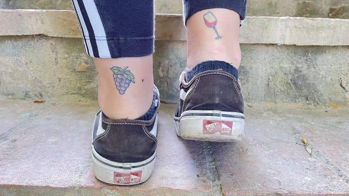 ankle tattoos of bunch of grapes and wine glass