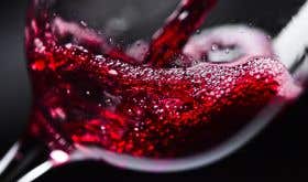 Generic red wine splashing into a glass